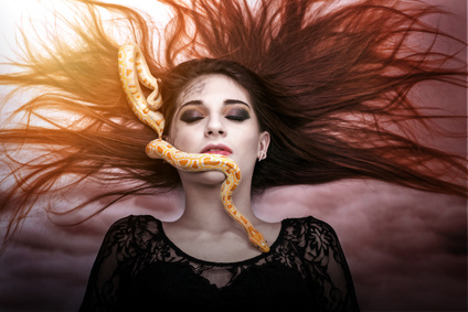 Woman lying on the floor with eyes closed, face the snake slither-awesome